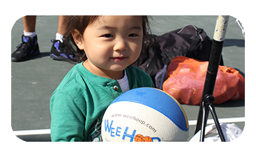 Little girl holding a small basketball